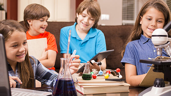 Children doing science homework at home.